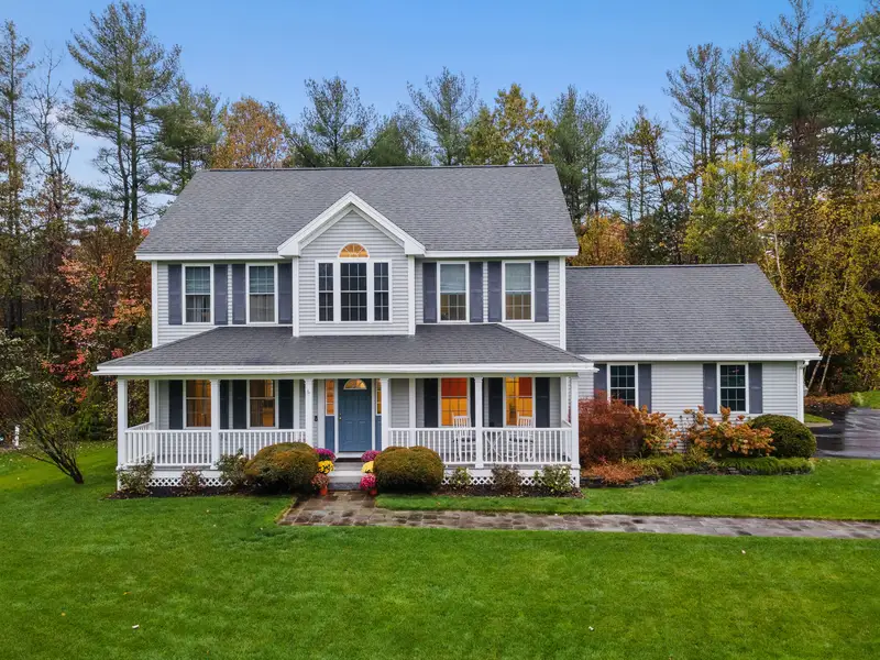 Classic colonial home with fresh gray exterior paint and white porch.