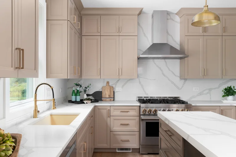 Professional kitchen cabinet painting in a modern taupe finish.