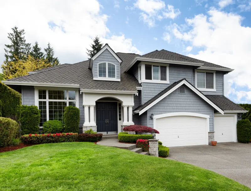 Light blue-gray residential home exterior with professional paint job.