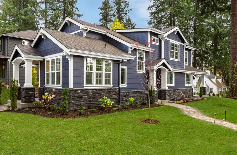 Navy blue craftsman home exterior featuring crisp white trim details.