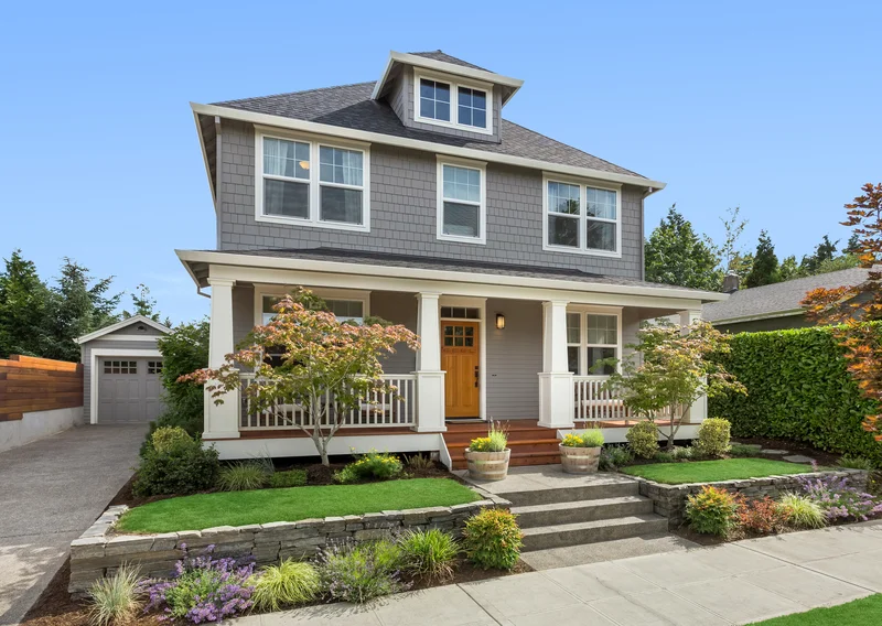 Craftsman home exterior with grey siding and white painted trim
